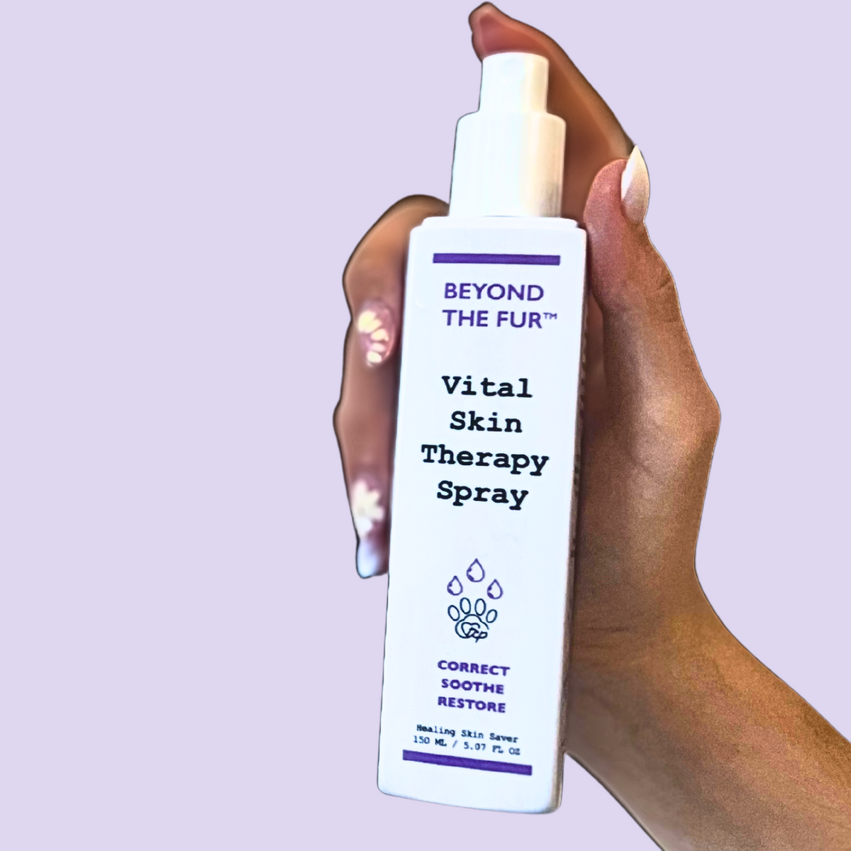 Hand holding a 'Beyond the Fur' Vital Skin Therapy Spray against a light purple background